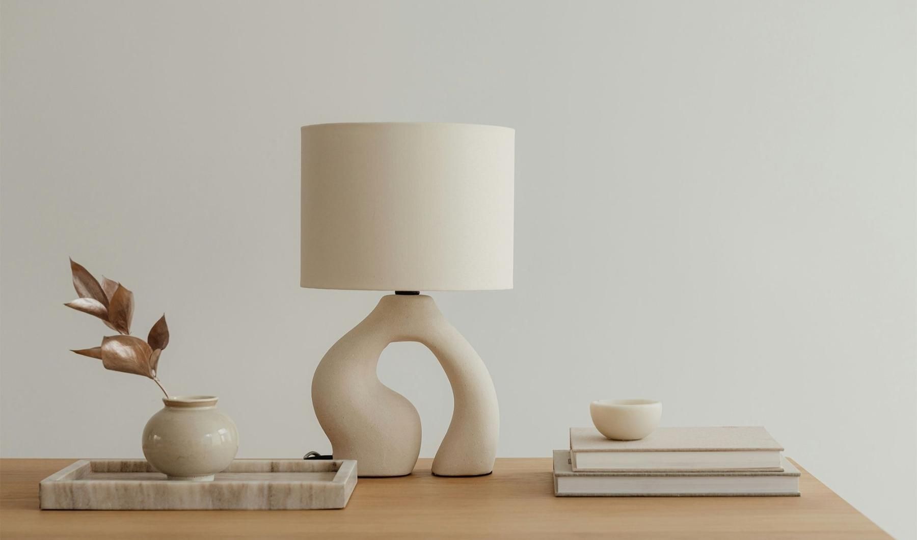 a lamp, stack of books, and decor